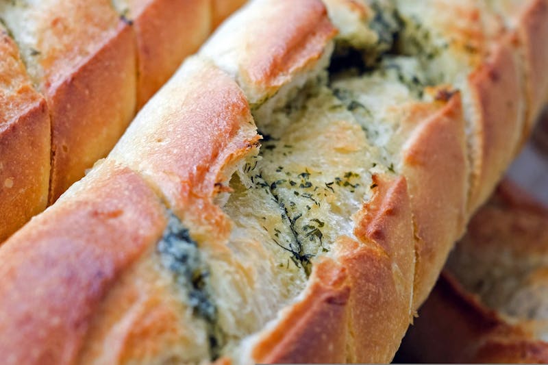 Freshly baked garlic knots with herb butter