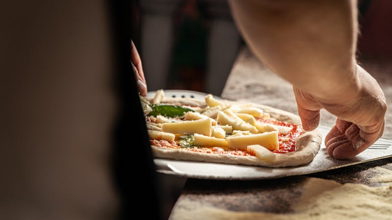 Dewey's pizza team working together in a friendly kitchen environment