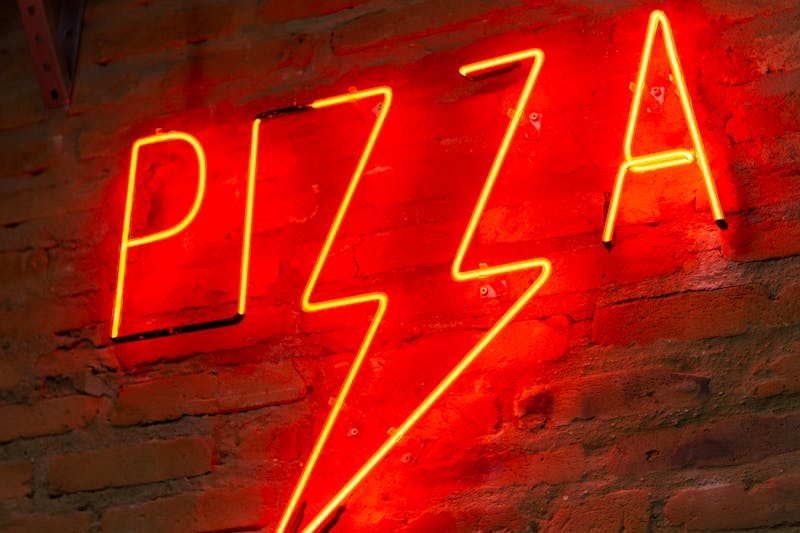 Artisan pizza preparation at Dewey's pizza — hand tossed dough